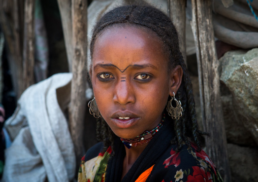 Oromo girl with facial tattoos and silver earrings, Oromo, Sambate, Ethiopia