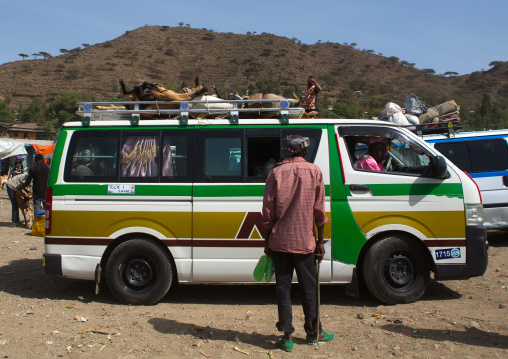 Goats tied on the roof of a mini bus leaving the market, Oromo, Sambate, Ethiopia