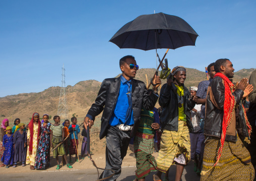 Oromo groom with an umbrella during his wedding celebration, Oromo, Sambate, Ethiopia