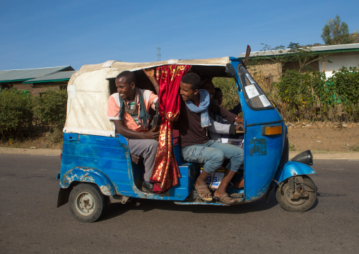 Men in a tuk tuk taxi looking backwards, Oromo, Sambate, Ethiopia