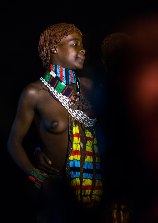 Hamer tribe teenage girl dancing at night, Omo valley, Turmi, Ethiopia