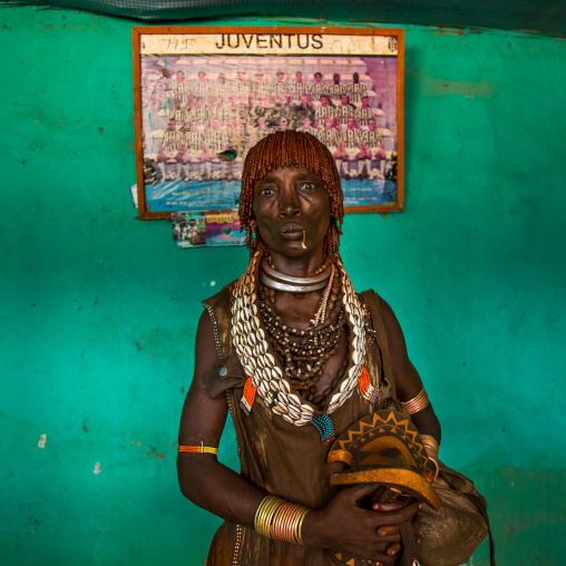 Hamer tribe woman in front of an old juventus poster, Omo valley, Turmi, Ethiopia