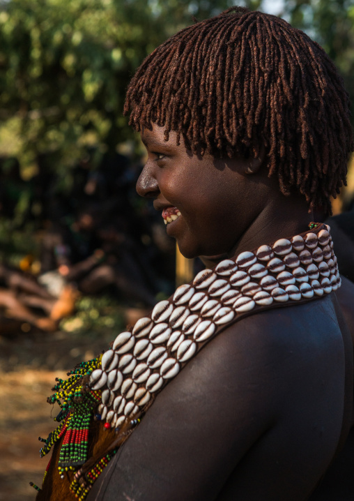 Hamer tribe woman with a shell necklace attending a bull jumping ceremony, Omo valley, Turmi, Ethiopia
