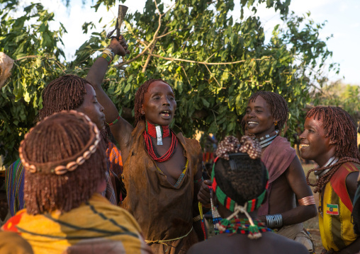 Hamer tribe women dancing during a bull jumping ceremony, Omo valley, Turmi, Ethiopia