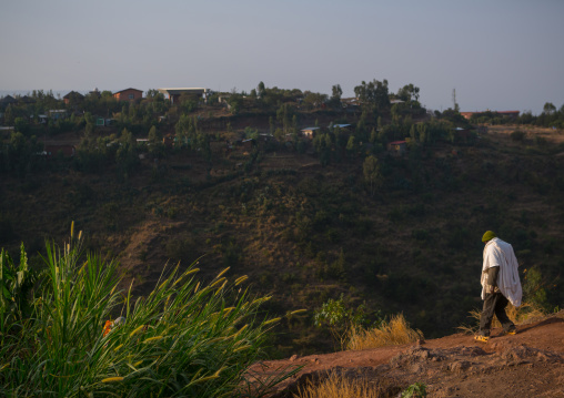Ethiopian man walking along a hill, Amhara region, Lalibela, Ethiopia