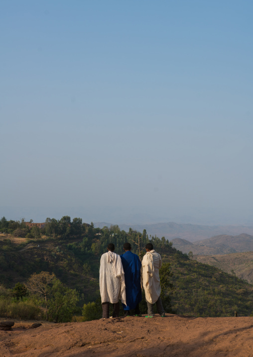 Ethiopian men walking along a hill, Amhara region, Lalibela, Ethiopia