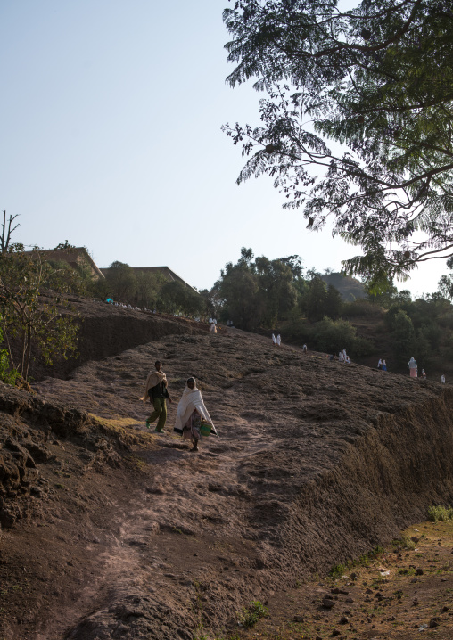 Ethiopian people walking along a hill, Amhara region, Lalibela, Ethiopia