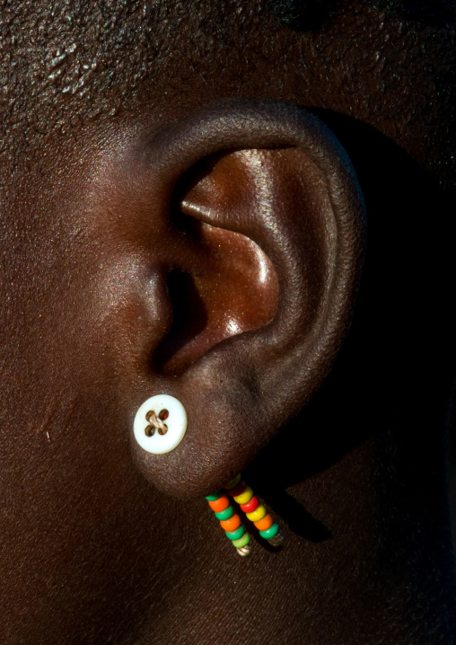 Hamer tribe girl with a button used as earring, Omo valley, Turmi, Ethiopia
