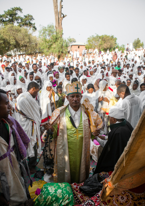 Priest blessing pilgrims during kidane mehret orthodox celebration, Amhara region, Lalibela, Ethiopia