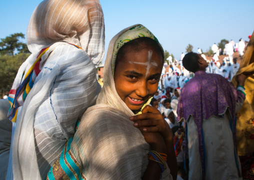 Pilgrim girl with a cross sign on the forehead during kidane mehret orthodox celebration, Amhara region, Lalibela, Ethiopia