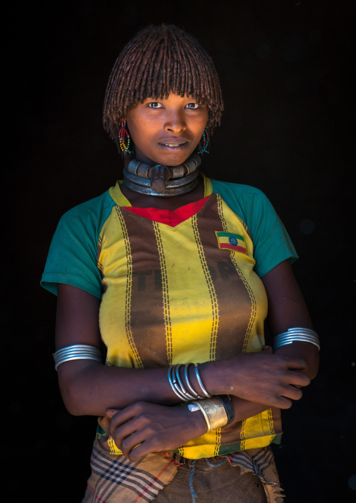 Portrait of a hamer tribe woman with ethiopia football shirt, Omo valley, Turmi, Ethiopia