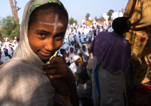 Pilgrim girl with a cross sign on the forehead during kidane mehret orthodox celebration, Amhara region, Lalibela, Ethiopia