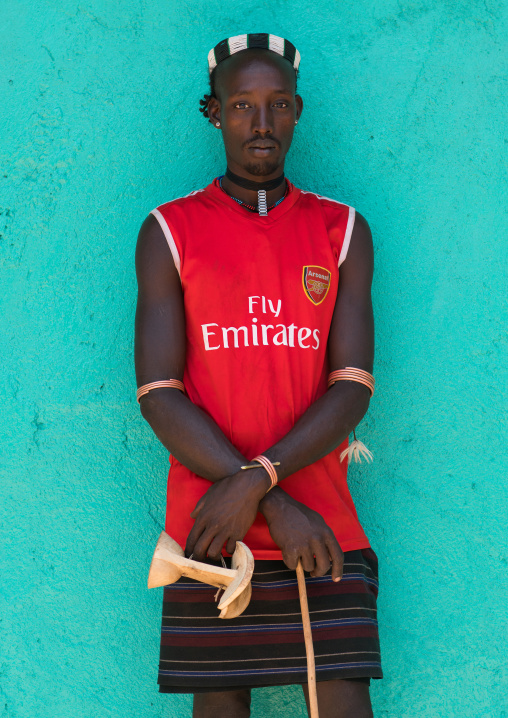 Portrait of a hamer tribe man with arsenal football shirt, Omo valley, Turmi, Ethiopia