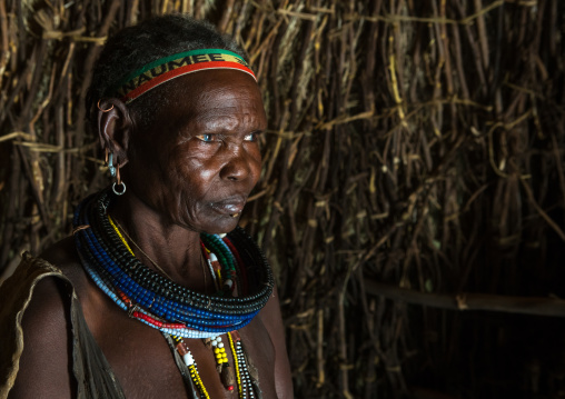 Toposa tribe woman in her hut, Omo valley, Kangate, Ethiopia