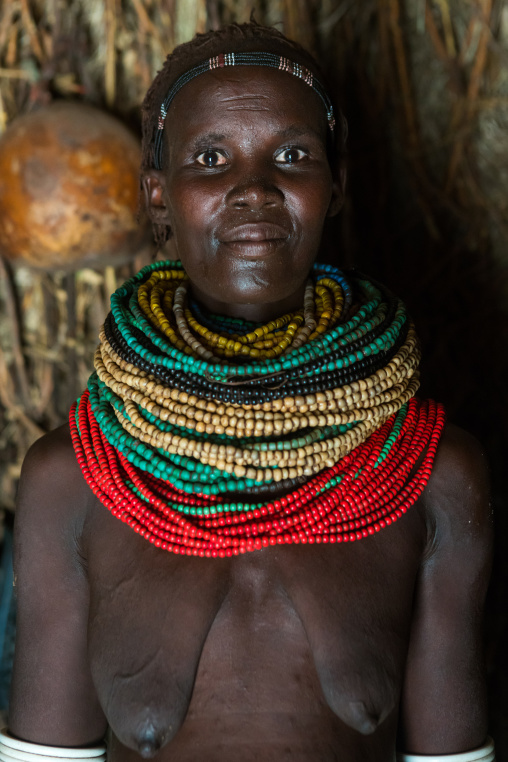 Nyangatom tribe woman with piles of beads, Omo valley, Kangate, Ethiopia