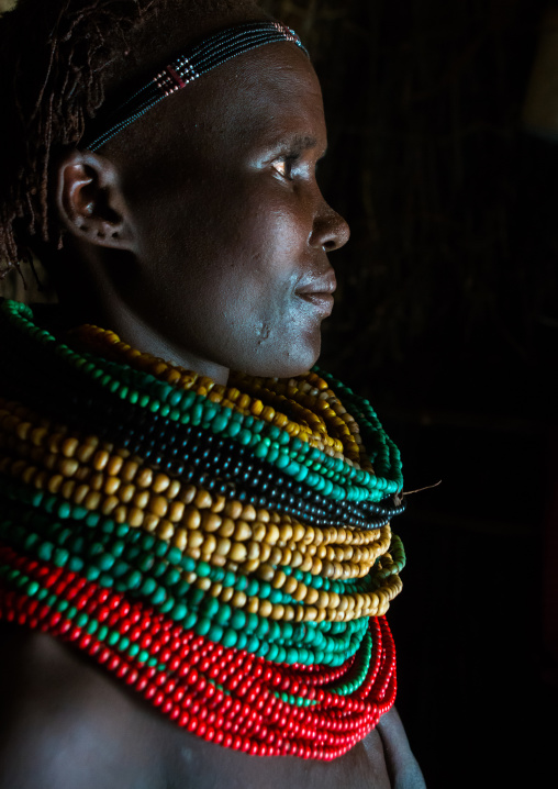 Nyangatom tribe woman profile with piles of beads, Omo valley, Kangate, Ethiopia