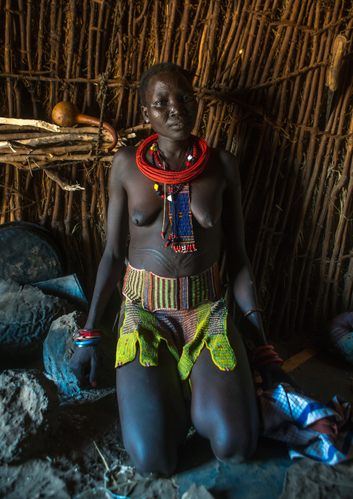 Toposa tribe woman with a beaded belt, Omo valley, Kangate, Ethiopia