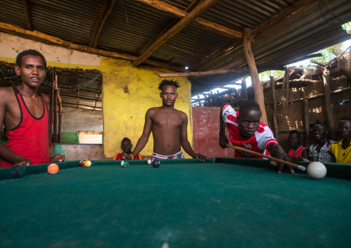 Young men playing snooker pool, Omo valley, Kangate, Ethiopia