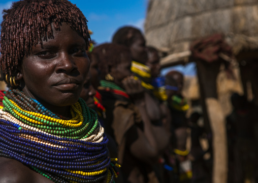 Nyangatom tribe women with huge necklaces in a line, Omo valley, Kangate, Ethiopia