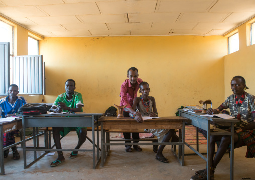 Hamer tribe teenage boys in classroom with their teacher, Omo valley, Turmi, Ethiopia
