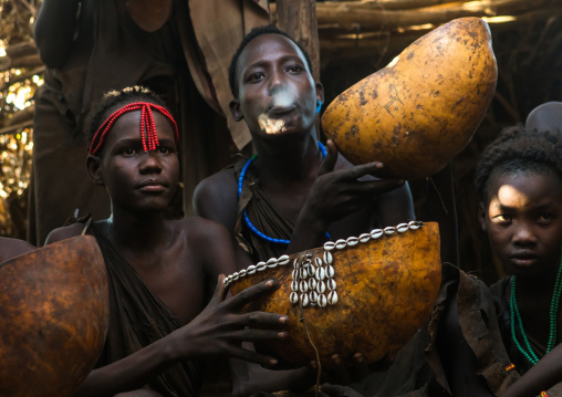 Circumcised boys from the dassanech tribe spitting to bless the visitors, Omo valley, Omorate, Ethiopia