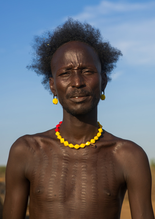 Dassanech man with scarifications on the chest that shows he killed a man, Omo valley, Omorate, Ethiopia