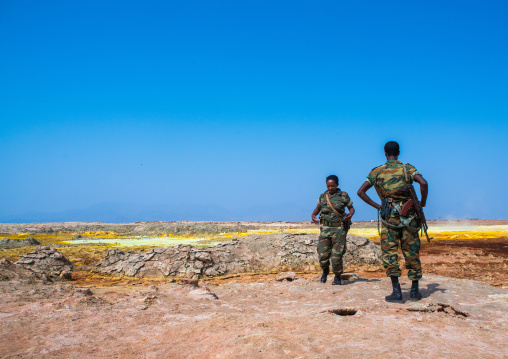 Ethiopian soldiers in front of colorful volcanic landscape in the danakil depression, Afar region, Dallol, Ethiopia