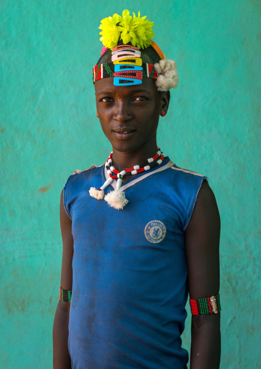 Portrait of a bana tribe man with plastic flowers in the hair and chelsea football shirt, Omo valley, Key afer, Ethiopia