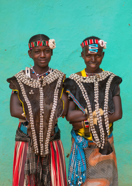 Portrait of a tsemay tribe girls with traditional goat skin clothes, Omo valley, Key afer, Ethiopia