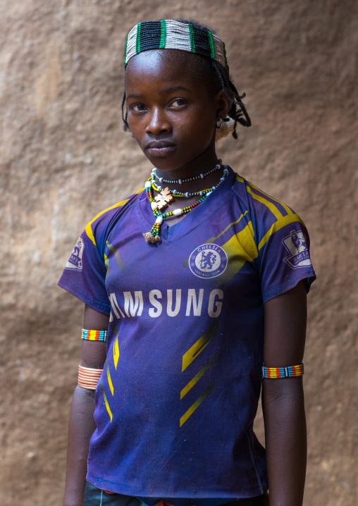 Portrait of a ban tribe gilr with a chelsea football shirt, Omo valley, Key afer, Ethiopia