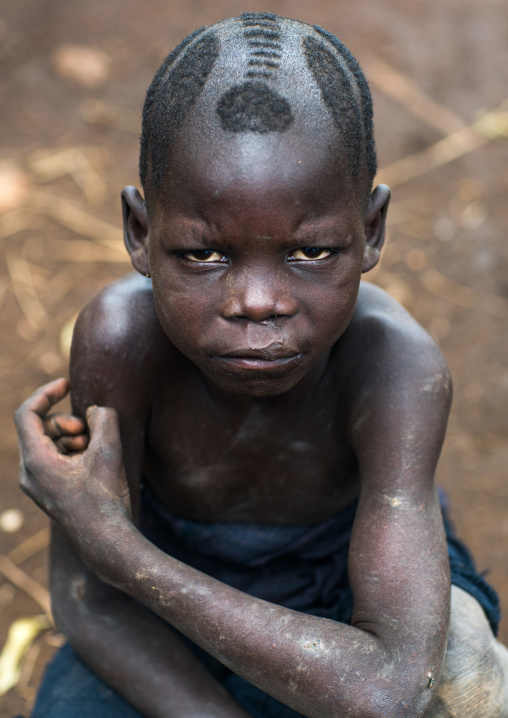 Mursi tribe kid with traditional hairstyle, Omo valley, Mago park, Ethiopia