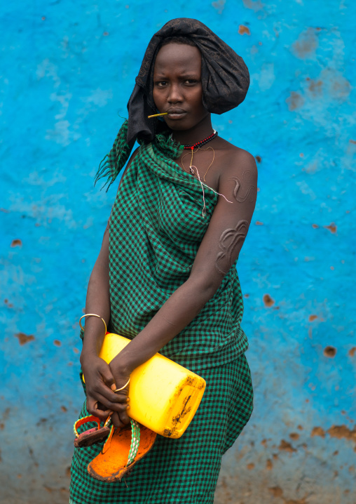Bodi tribe woman with impressive scarifications on the arm, Omo valley, Hana mursi, Ethiopia