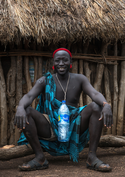 Portrait of a bodi tribe chief with a plastic bottle around his neck, Omo valley, Hana mursi, Ethiopia