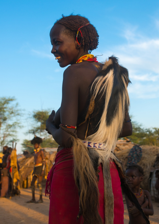 Dassanech tribe woman with colobus monkey skin during dimi ceremony to celebrate circumcision of teenagers, Omo valley, Omorate, Ethiopia