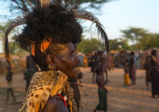 Dassanech man with leopard skin and ostrich feather headwears during dimi ceremony to celebrate circumcision of teenagers, Omo valley, Omorate, Ethiopia