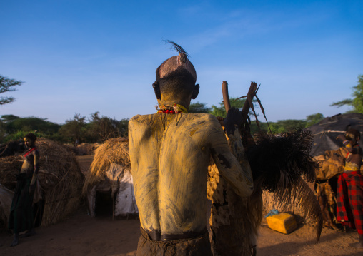 Dassanech man preparing himself for dimi ceremony to celebrate circumcision of teenagers, Omo valley, Omorate, Ethiopia