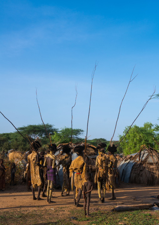 Dassanech men with leopard skins and ostrich feathers headwears during dimi ceremony to celebrate circumcision of teenagers, Omo valley, Omorate, Ethiopia