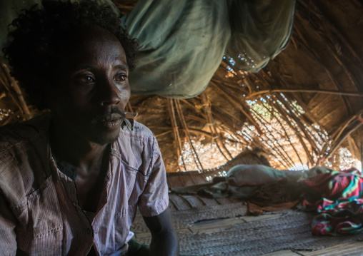 Afar tribe man inside his hut, Afar region, Afambo, Ethiopia