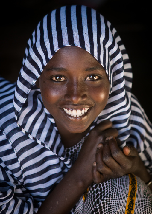Portrait of a smiling afar tribe teenage girl, Afar region, Afambo, Ethiopia