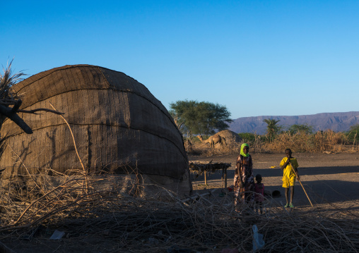 Afar tribe people in front of their oval-shaped hut, Afar region, Afambo, Ethiopia
