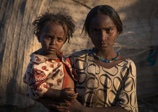 Portrait of an afar tribe teenage girl with a todder, Afar region, Afambo, Ethiopia