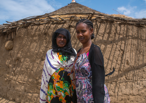 A karrayyu tribe girl called aliya who was the first girl educated in her tribe pausing with her mother, Oromia, Metehara, Ethiopia