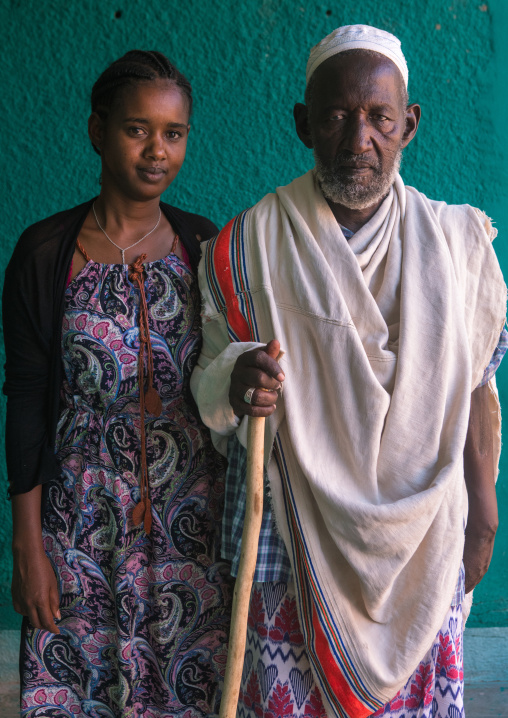 A karrayyu tribe girl called aliya who was the first girl educated in her tribe pausing with her father, Oromia, Metehara, Ethiopia