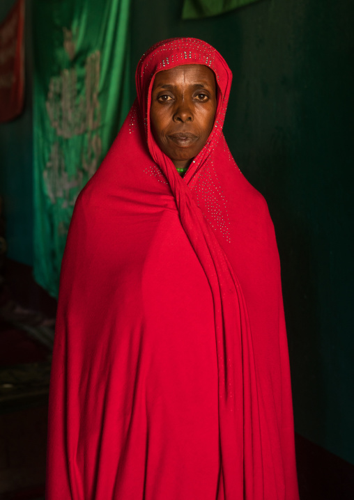 Sufi woman worshipper in red veil, Harari region, Harar, Ethiopia