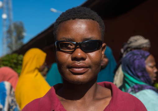 Man wearing sunglasses with one glass missing, Harari region, Awaday, Ethiopia