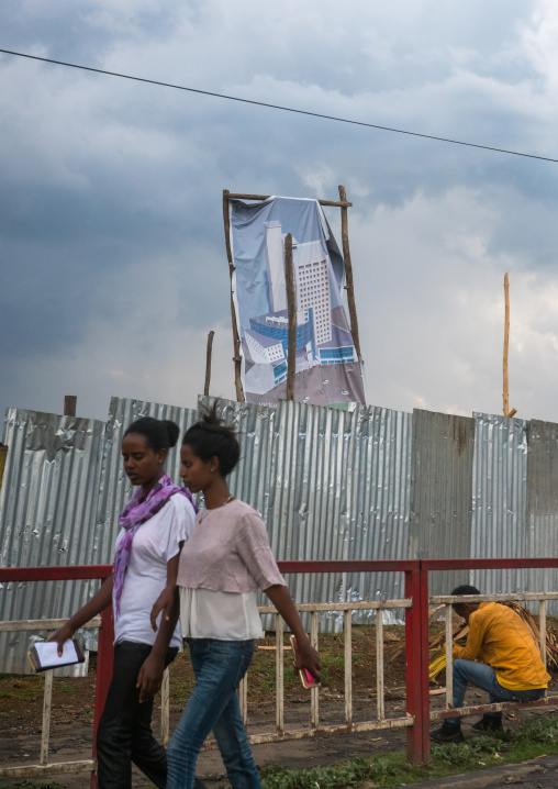 Women passing in front a real estate billboard, Addis abeba region, Addis ababa, Ethiopia
