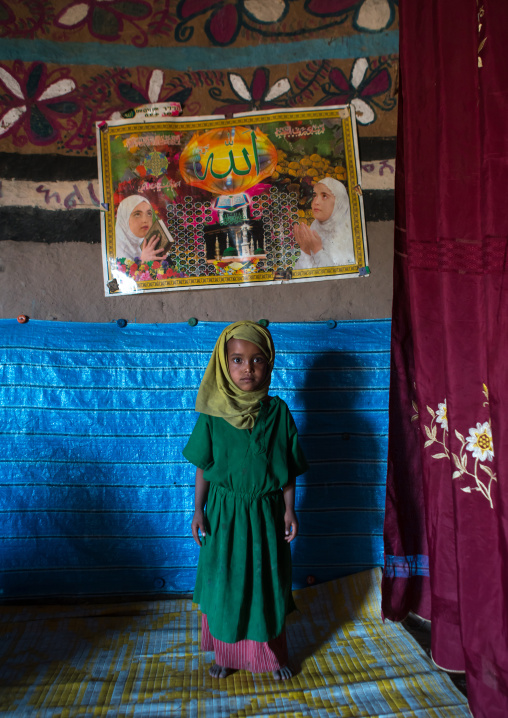 Ethiopia, Kembata, Alaba Kuito, girl in front of a muslim poster inside her house