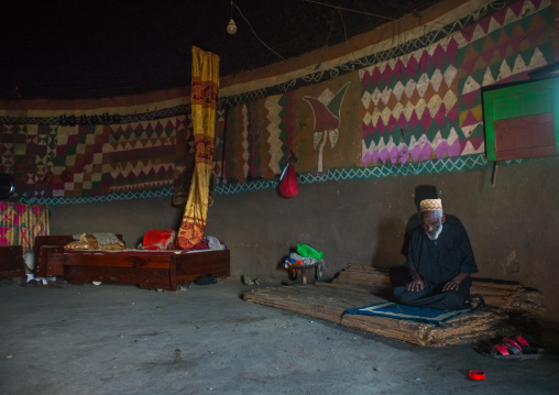 Ethiopia, Kembata, Alaba Kuito, ethiopian muslim man praying inside his traditional painted and decorated house