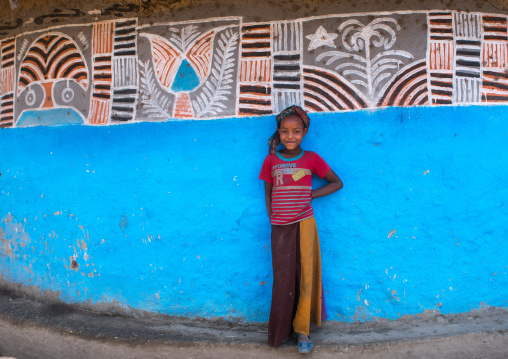 Ethiopia, Kembata, Alaba Kuito, ethiopian girl standing in front of her traditional painted house