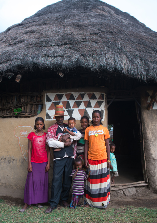 Ethiopia, Kembata, Alaba Kuito, family standing in front of a traditional painted house